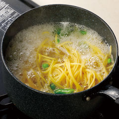 塩を入れて沸騰させたお湯にじゃがいもを入れ、煮立ったらスナップエンドウを加える。再び煮立ったらスパゲッティも加えて袋の表示時間より１分短く茹でる。茹で汁は取っておく。